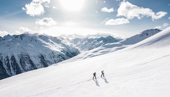 two cross country skiiers on an alpine slope