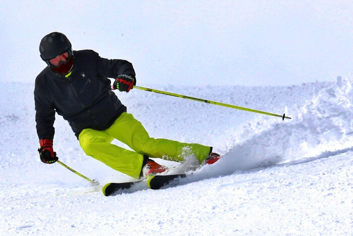 skier sliding down snowy slope