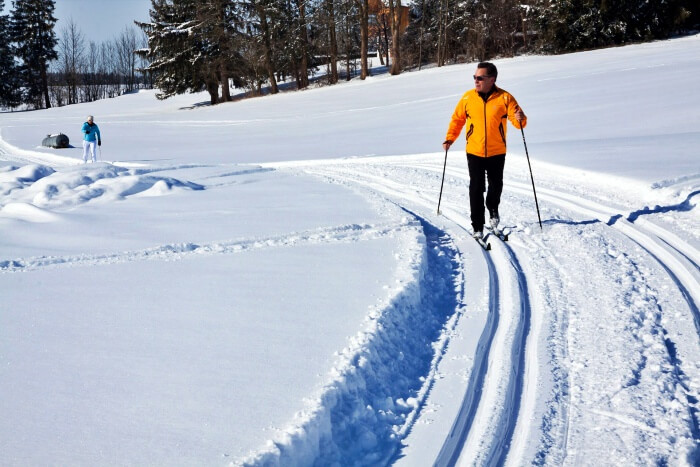 cross country skier on snowy trail 