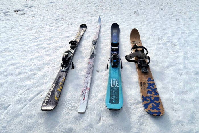 four different skis on snow