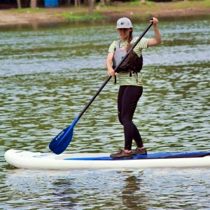 woman on paddle board wearing life jacket
