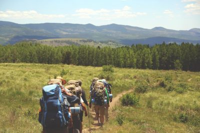 line of backpackers on hill 