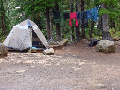 tent in campground with clothes left to dry on a clothes line 