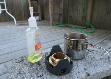 alcohol stove and alcohol bottle near can 