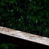 rain falling on wood ledge