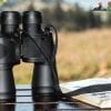 best binoculars for the money on table beside book